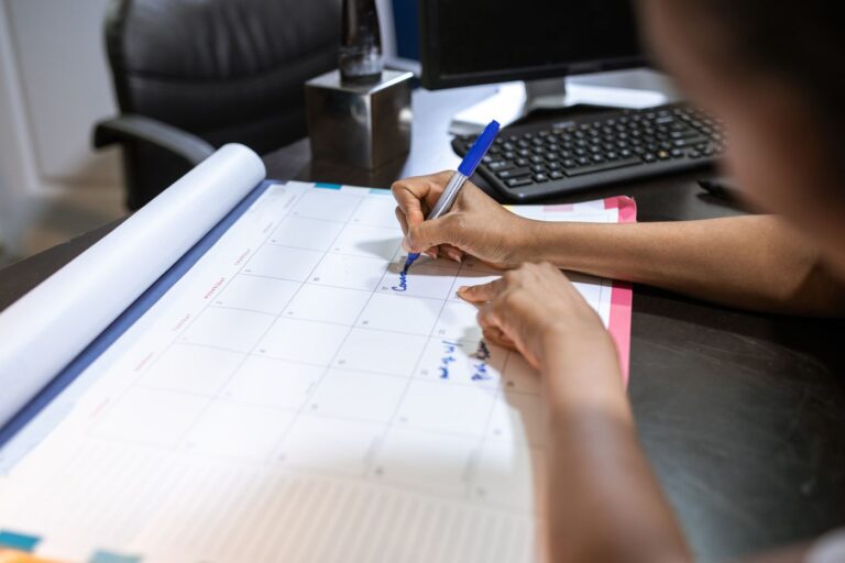 Marking dates in a desk calendar to track upcoming renewals
